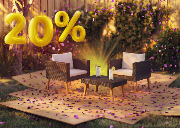 Cadeir&otilde;es lounge de rattan para exterior com almofadas e uma pequena mesa num ambiente de jardim, decorados com confetes cor-de-rosa e bal&otilde;es dourados com &laquo;20% de desconto&raquo;, destacando promo&ccedil;&otilde;es sazonais em mobili&aacute;rio lounge de jardim.